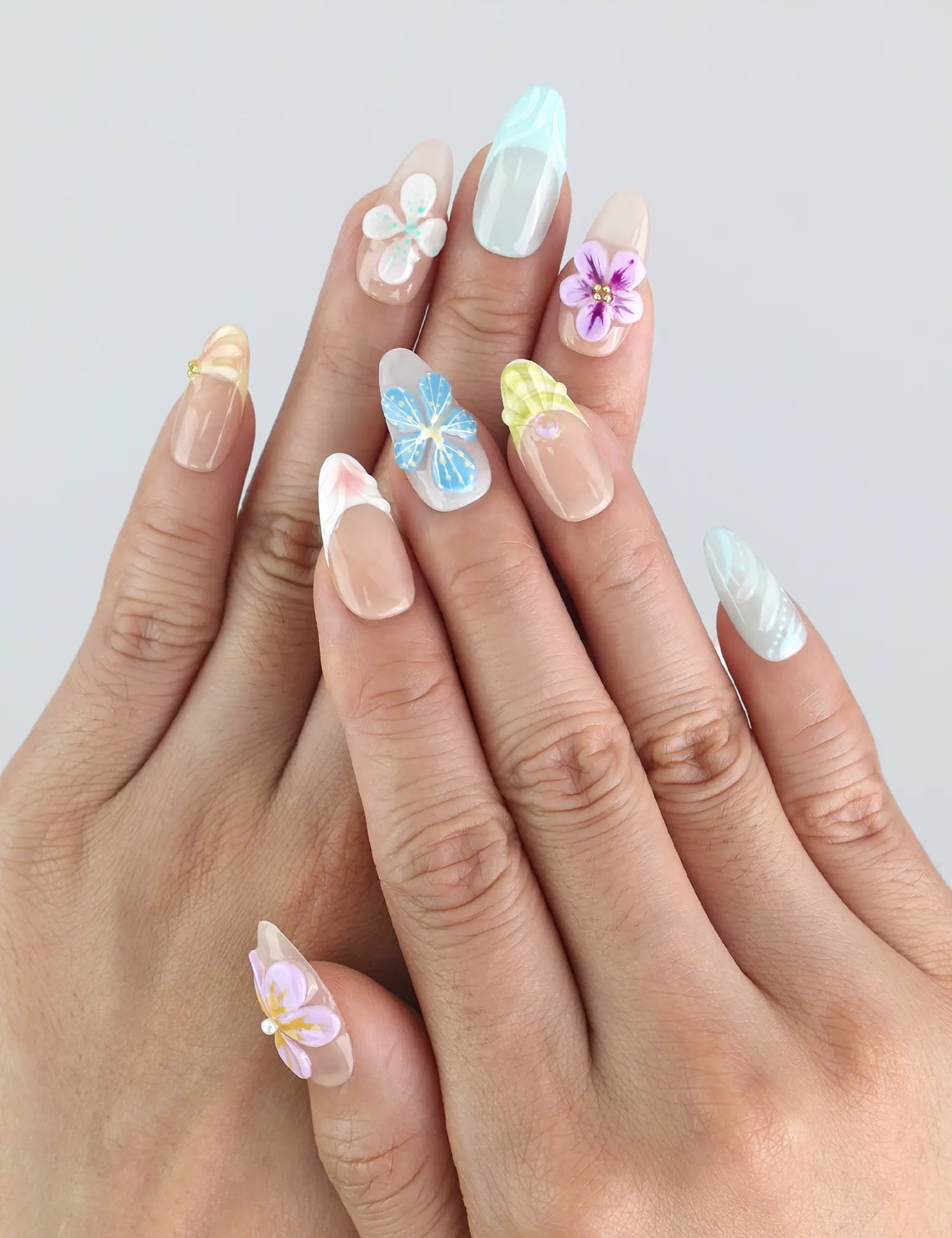 Model wearing Naillover Bloom Harmony press on nails — pastel pink and lavender nails with 3D floral accents, handmade in Singapore.