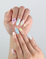 Close-up of Naillover Bloom Harmony on hand — delicate press on nails with pastel tones and raised floral details for a cute coquette look.