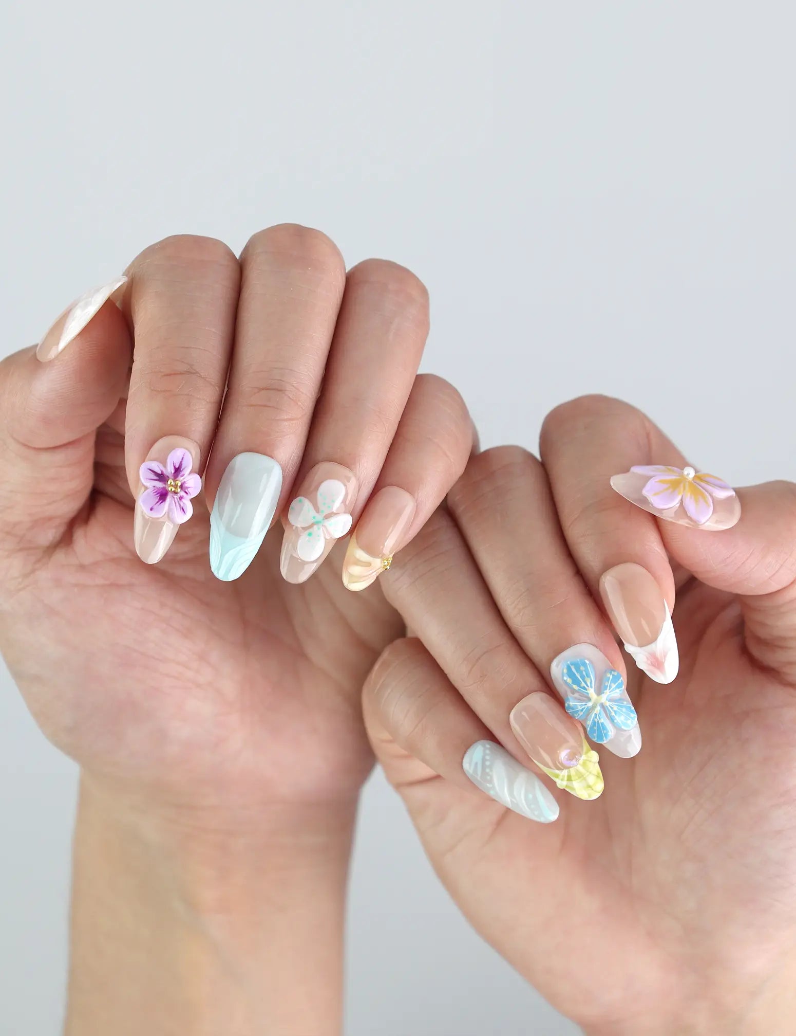 Styled hand pose featuring Naillover handmade press on nails — Bloom Harmony in soft hues, ideal for spring fashion and Singapore nail lovers.