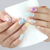 Naillover Bloom Harmony press on nails shown holding a drink — pastel floral nails from Singapore with charming 3D details, perfect for brunch looks.