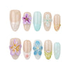 Flat-lay of Naillover Bloom Harmony press on nails — 3D flower accents and pastel shades, part of our handmade Singapore press on nails line.