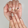 Close-up of Naillover handmade Blossom Latte press on nails showing delicate floral design and luxurious details