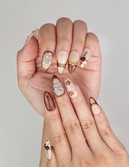 Close-up of Naillover handmade Blossom Latte press on nails showing delicate floral design and luxurious details