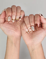 Naillover Blossom Latte Singapore press on nails styled on hand, elegant blend of creamy beige and floral accents