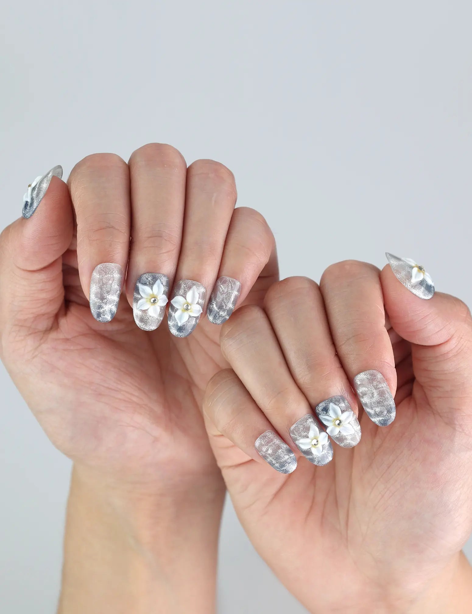 Elegant hand wearing Blue Blossom press on nails by Naillover—handmade 3D summer nails with coastal vibes and aesthetic.