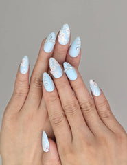 Model wearing Naillover Blue Floral Diamond Singapore press on nails with matte blue base and delicate white floral accents