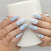 Naillover Blue Floral Diamond press on nails SG shown while holding a cup, featuring floral art with pearls and crystals