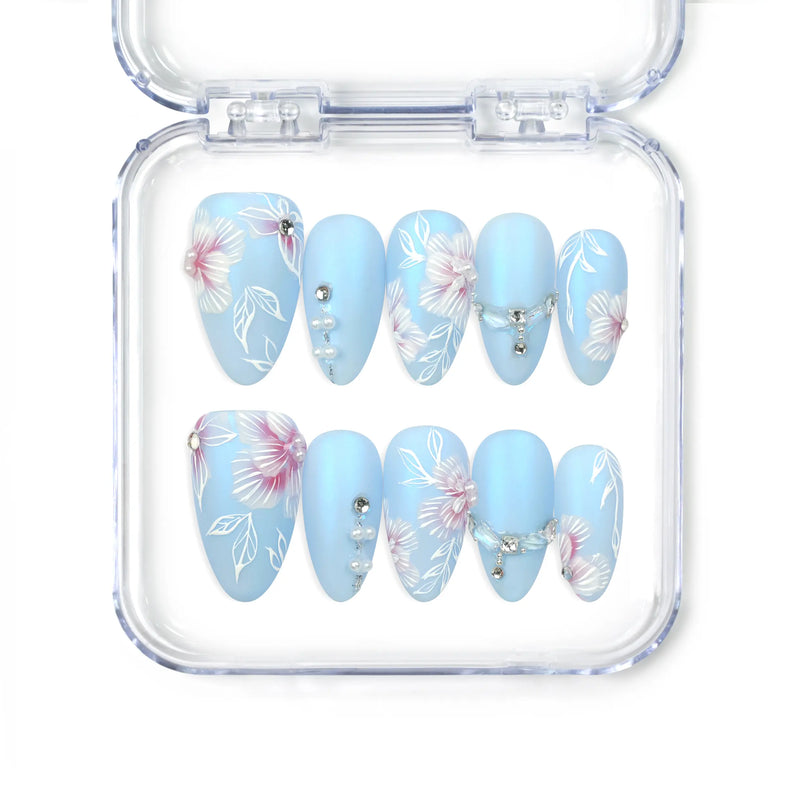Naillover Blue Floral Diamond Singapore press on nails with matte blue base, white floral art, and pearl crystal accents