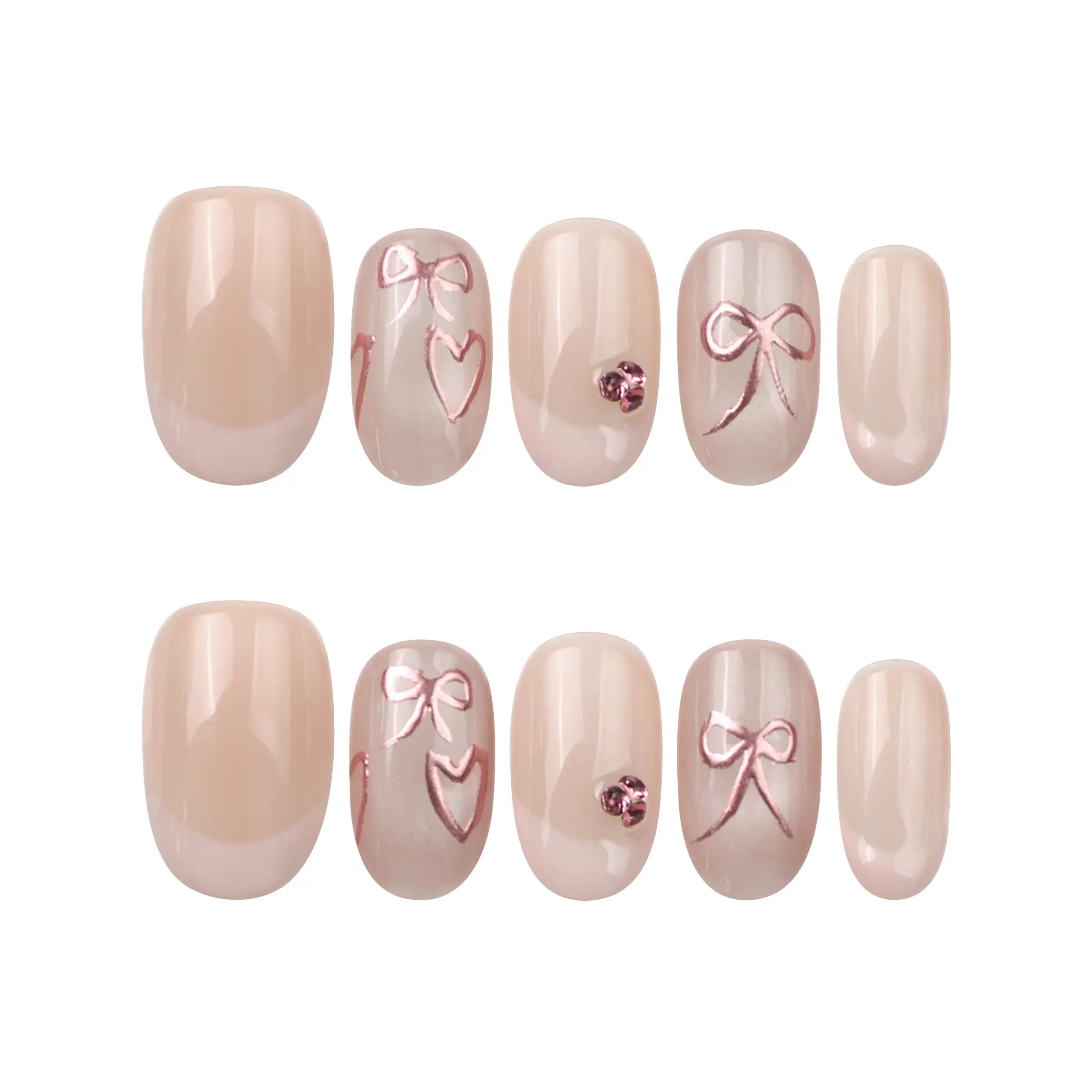 Flat lay of Naillover Blush Bowlet nails—short oval nude press on nails with French tips, hearts, and bow decorations.