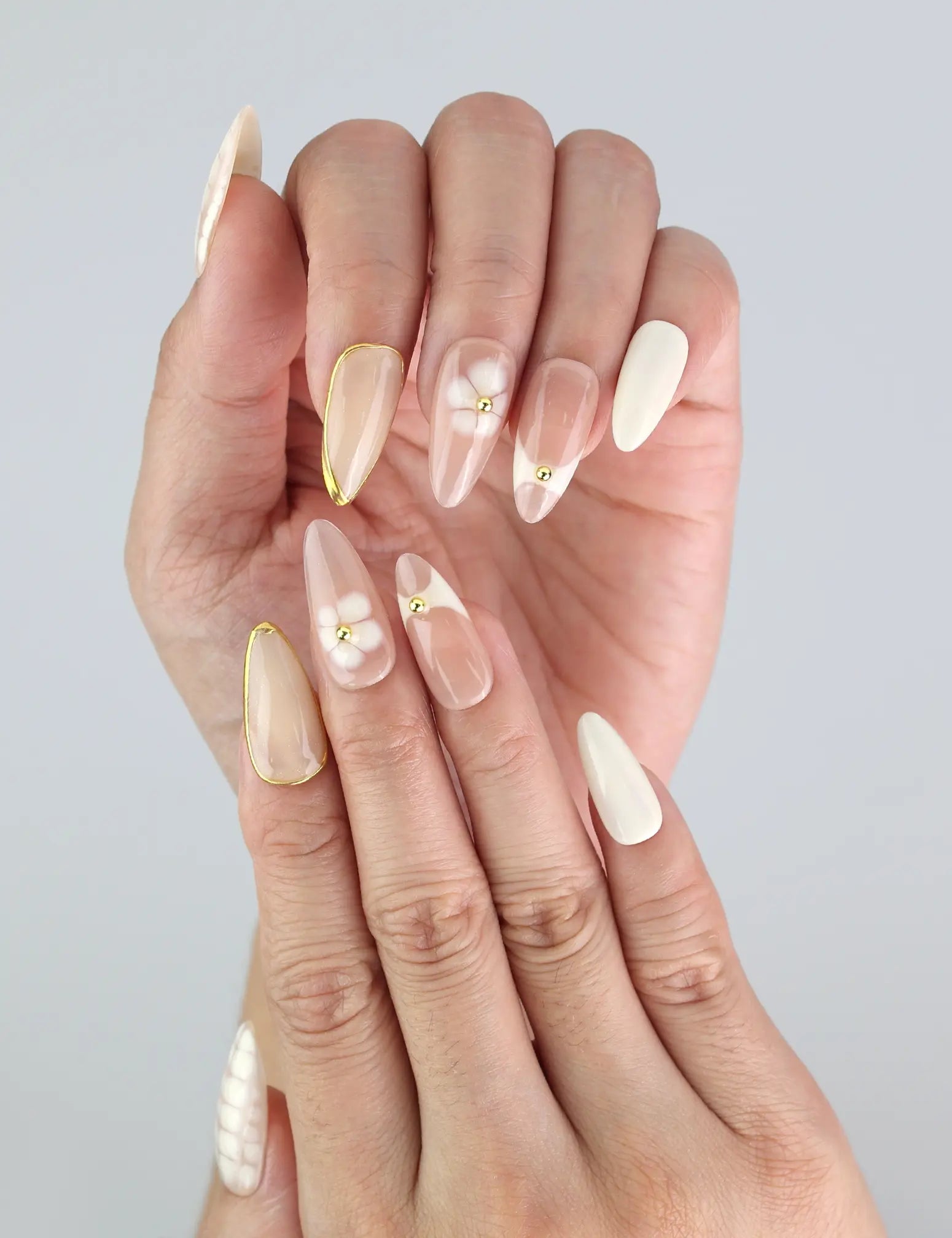 Close-up of Naillover Blush Lattice nails on hand — soft summer tones and sleek almond silhouette from press on nails SG collection.