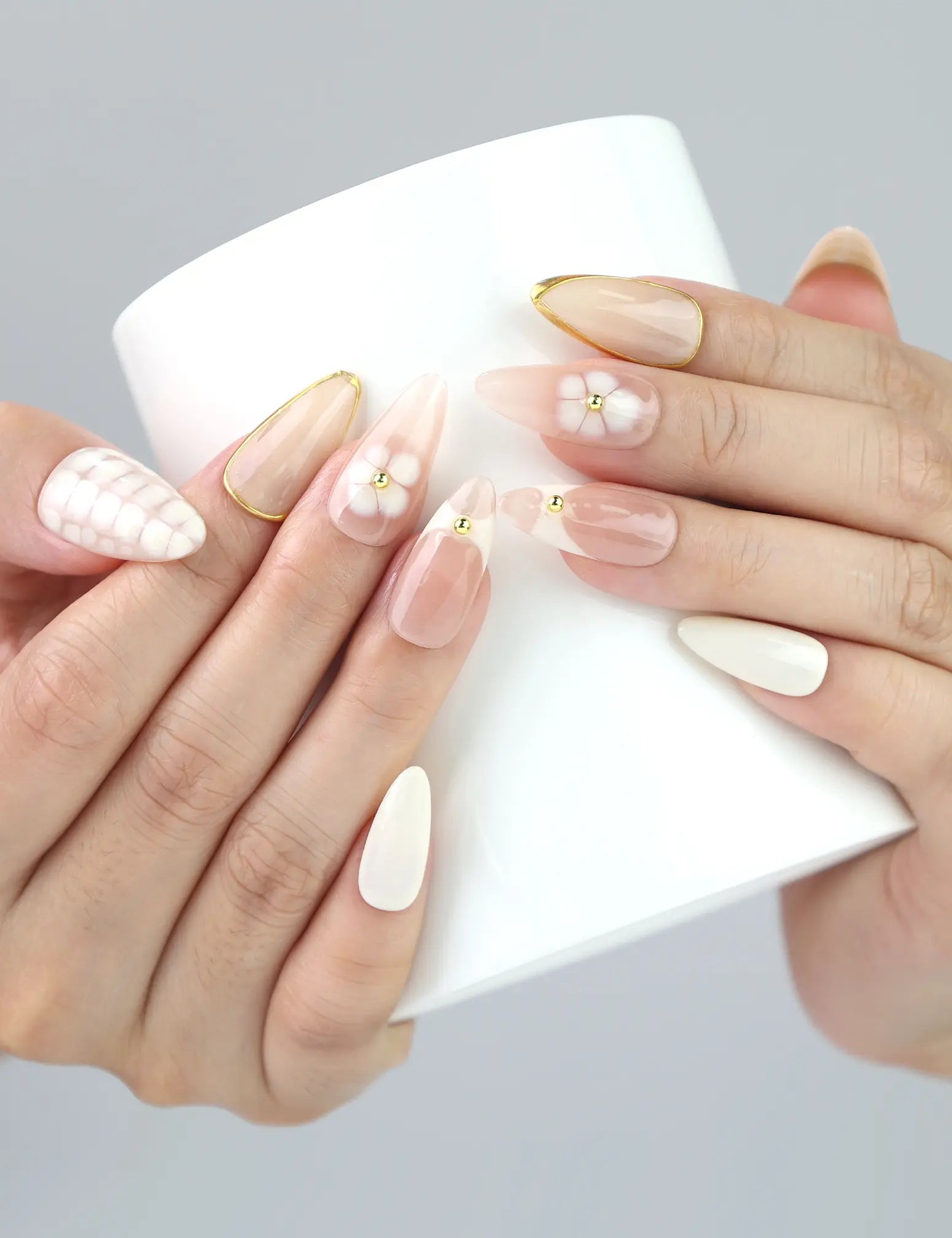 Hand holding iced drink with Naillover Blush Lattice nails — subtle gradient pink press on nails that pair summer charm with classic style.