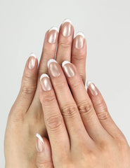Hand model wearing Champagne handmade press on nails, shimmering nude champagne shade, classic nails look by Naillover.