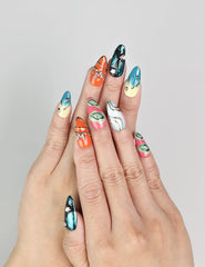 Model wearing Cosmo Glam handmade Singapore press on nails in vibrant Y2K style with retro patterns