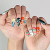 Hand pose with Cosmo Glam handmade Singapore press on nails showcasing vibrant retro patterns