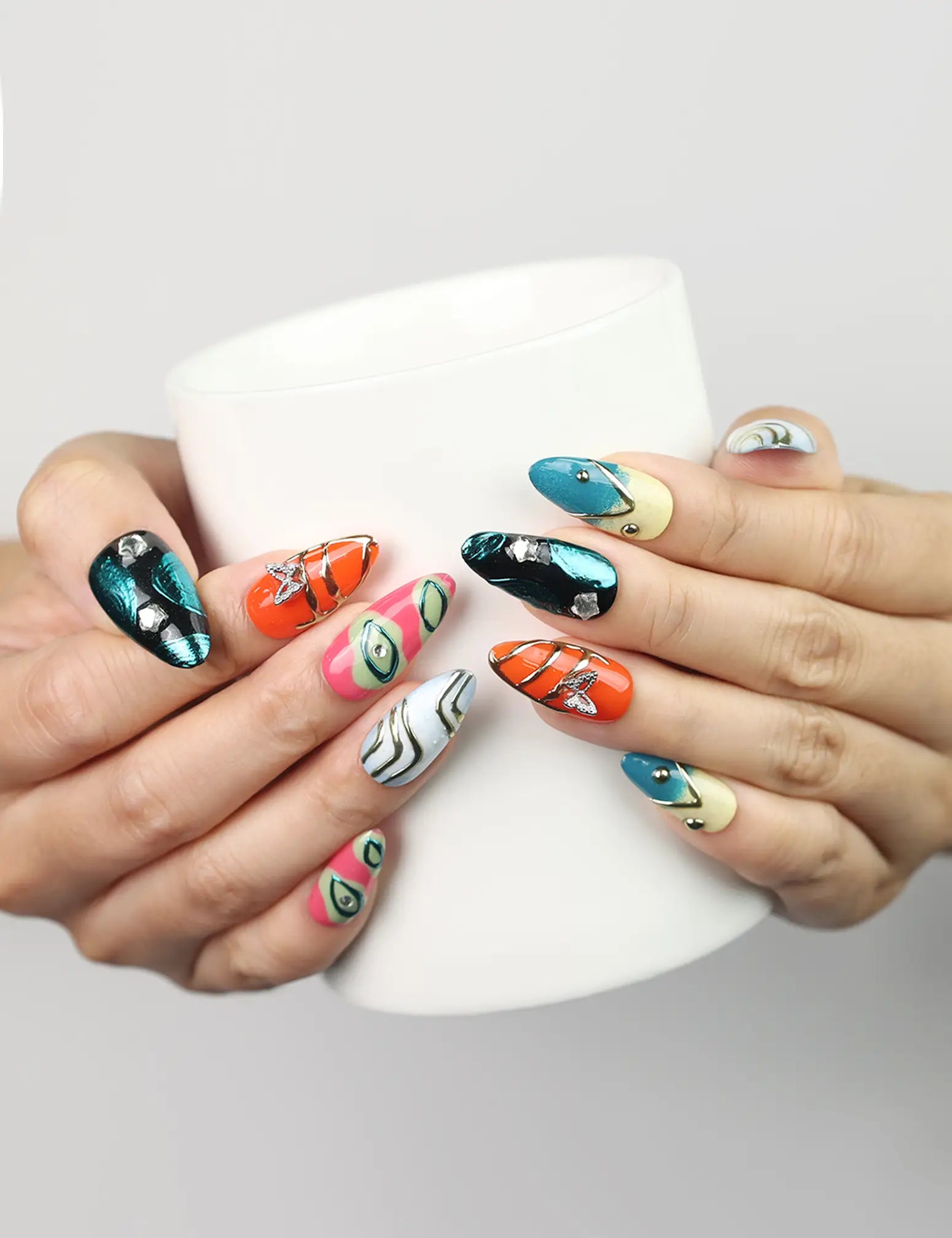 Cosmo Glam Singapore press on nails by Naillover in colorful Y2K style, shown holding a coffee cup