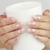 Hand holding a cup with Naillover Crystal Crescent Singapore press on nails with shimmering crystal accent