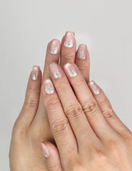 Model wearing Naillover Crystal Dew Singapore press on nails with shimmering cat eye design and silver glitter.