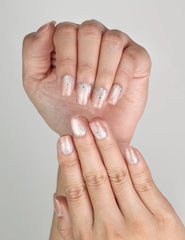Close-up of Naillover Crystal Dew handmade cat eye press on nails with silver glitter and white stars.