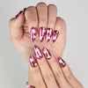 Close-up of Cupid's Curve Singapore press on nails by Naillover showing heart designs and sparkling rhinestone accents