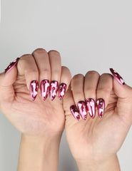 Romantic hand pose with Cupid's Curve handmade Singapore press on nails featuring magenta color and rhinestones
