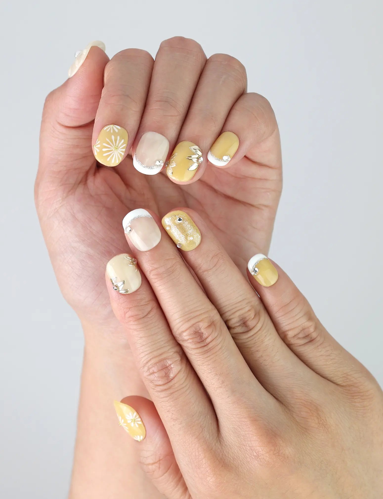 Side view of Naillover Daisy Glow nails showing clean nail shape, soft floral detail, and subtle handmade charm.
