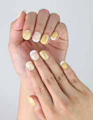 Side view of Naillover Daisy Glow nails showing clean nail shape, soft floral detail, and subtle handmade charm.