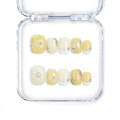 Flat lay of Naillover Daisy Glow Singapore press on nails with soft pastel base and minimalist daisy accents, handmade for a fresh, natural finish.