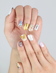 Close-up of Naillover handmade press on nails in Ethereal Shimmer—lilac tones with amber chrome and coquette nail details.