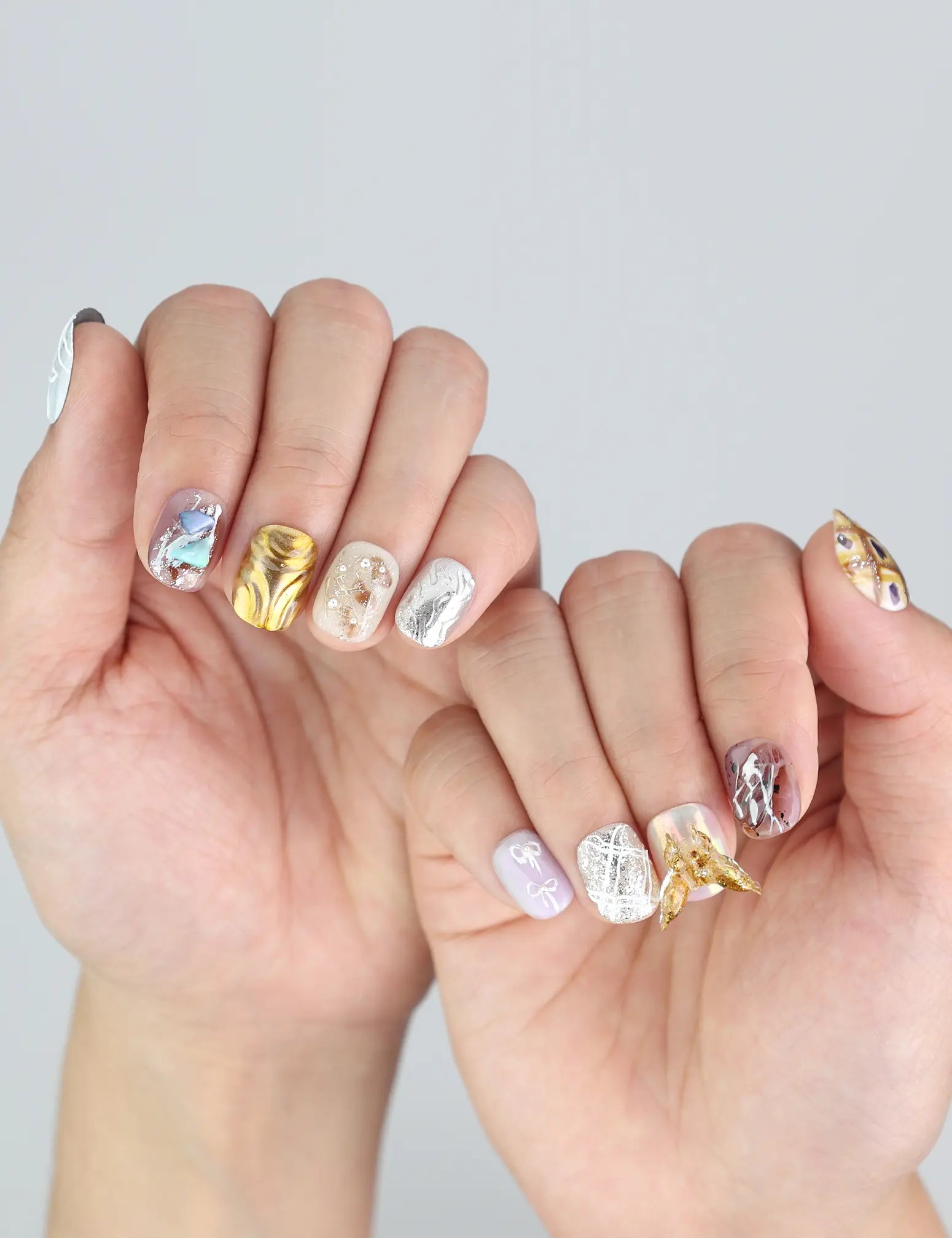Model hand showing Ethereal Shimmer Singapore press on nails—vibrant, cute short nails with shimmer and texture.