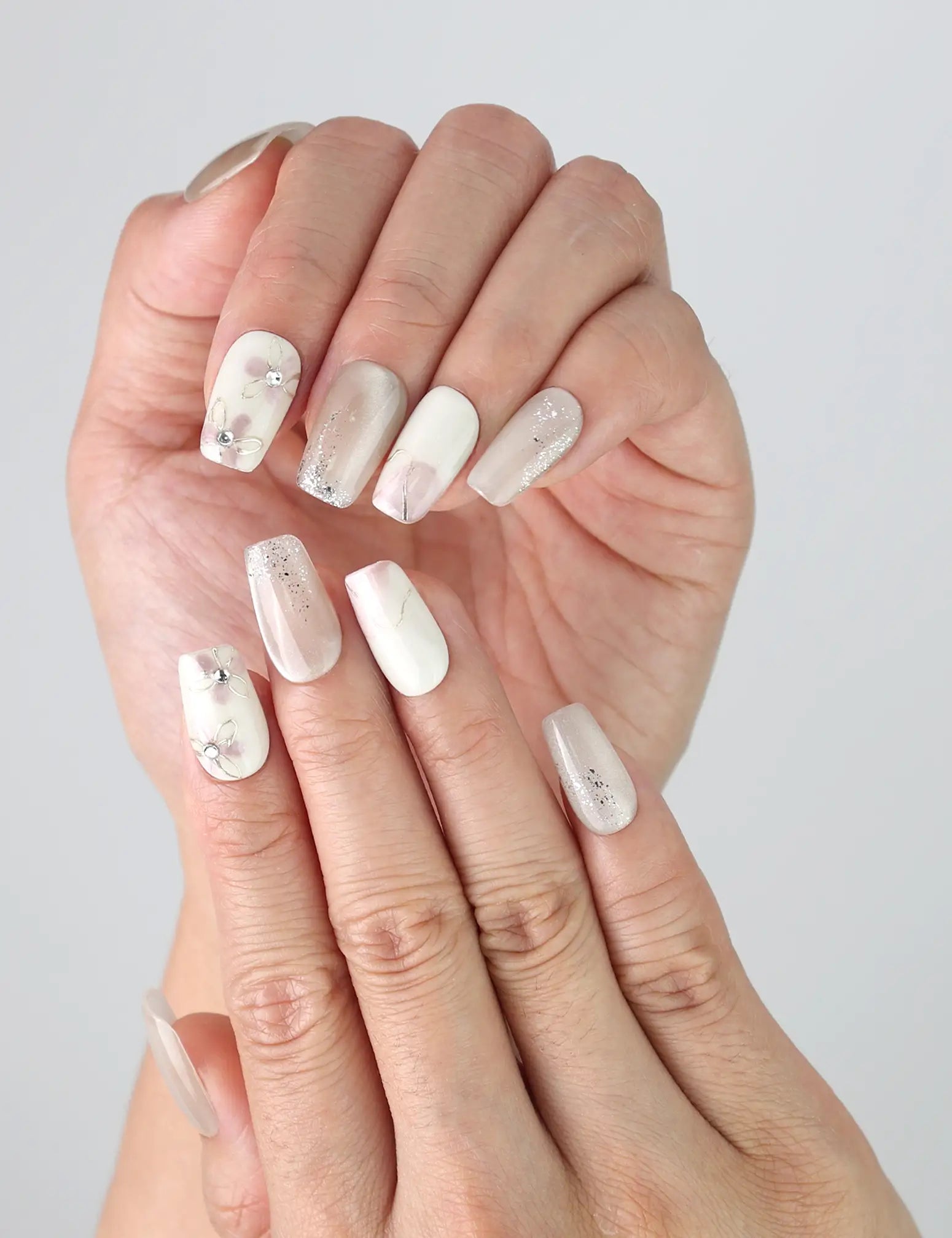 Side view of Flora Sheen Singapore press on nails worn on fingers, highlighting soft pastel blooms and handmade elegance.