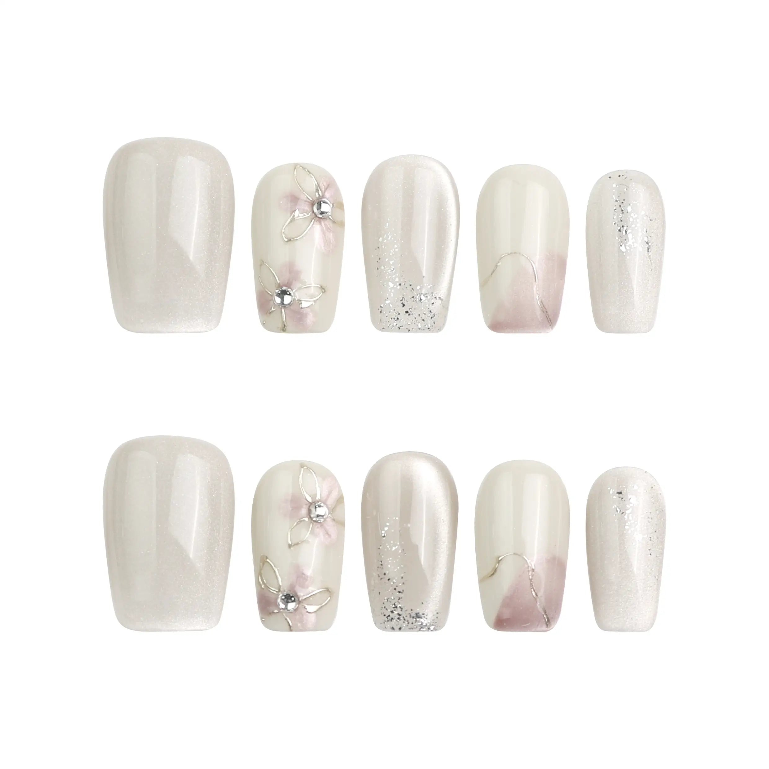 Flat lay of Flora Sheen handmade press on nails on a white background, showing gradient color flow and fine floral detail.