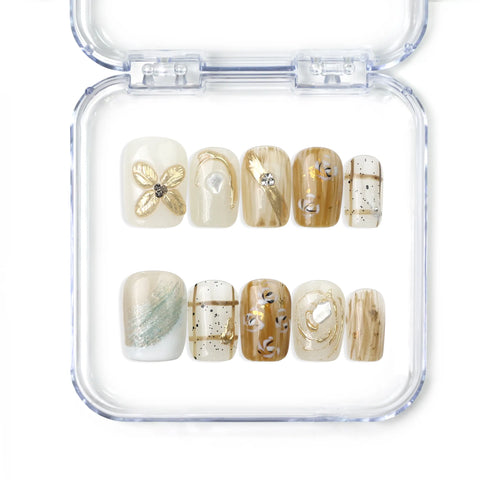 Naillover Gilded Grace handmade press on nails in soft beige with sculpted 3D floral accents and gold shimmer, from the Singapore press on nails collection.
