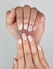 Close-up of Naillover Glimmer Blossom Singapore press on nails showing gold leaf details and subtle rhinestones.