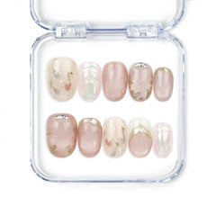 Naillover Glimmer Blossom handmade Singapore press on nails in soft pink with gold leaf patterns and rhinestone accents.