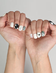 Naillover Inky Blossoms trendy handmade press on nails styled with a casual outfit, featuring bold floral accents.