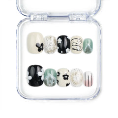 Naillover Inky Blossoms handmade press on nails Singapore in black, white, and green with floral and abstract nail art design.