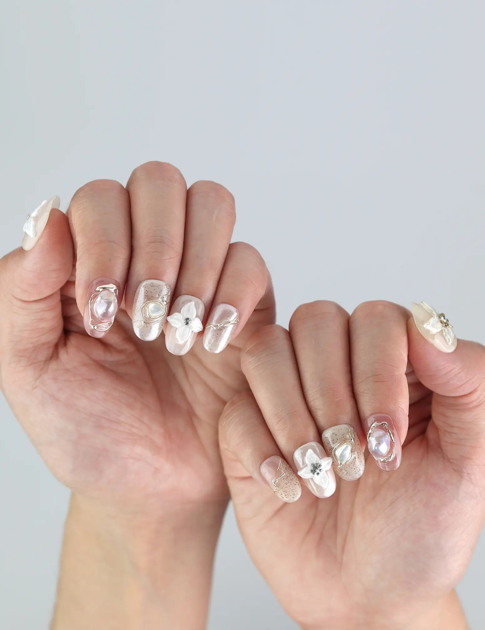 Elegant fingers adorned with Naillover’s Lace Flower press on nails—3D flowers in soft pastel hues perfect for weddings or spring events.