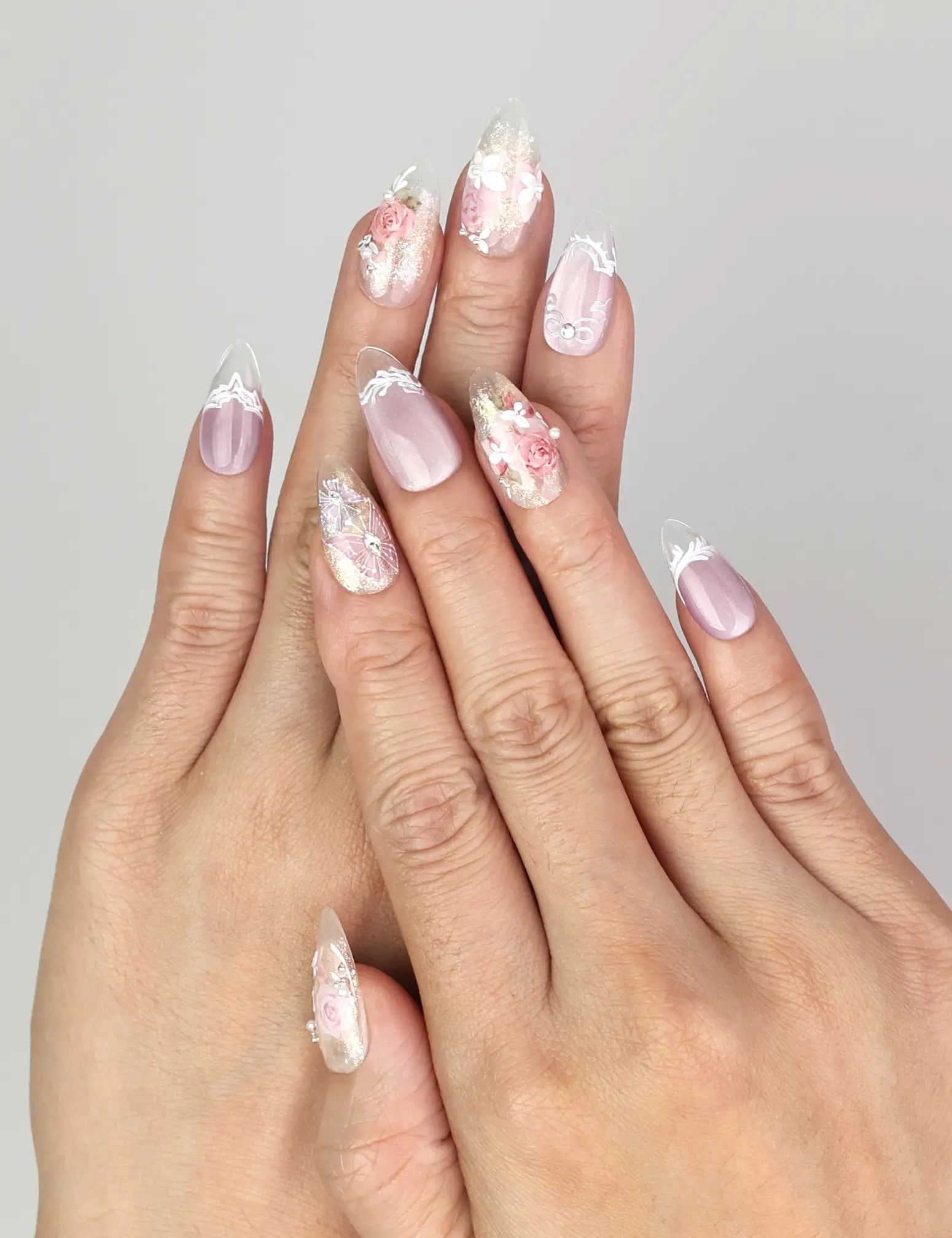 Close-up of Naillover Lavender Floral Dream handmade press on nails in lilac and white with delicate rose and pearl details.