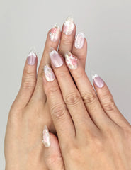Close-up of Naillover Lavender Floral Dream handmade press on nails in lilac and white with delicate rose and pearl details.