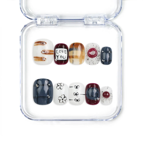 Naillover Love Notes handmade Singapore press on nails with bold dark and light tones, romantic words, and floral bow motifs.