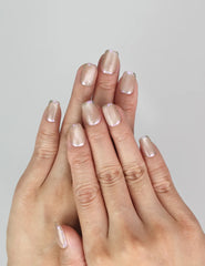 Model wearing Naillover Lucent Blooms handmade Singapore press on nails with pastel colors and floral accents.