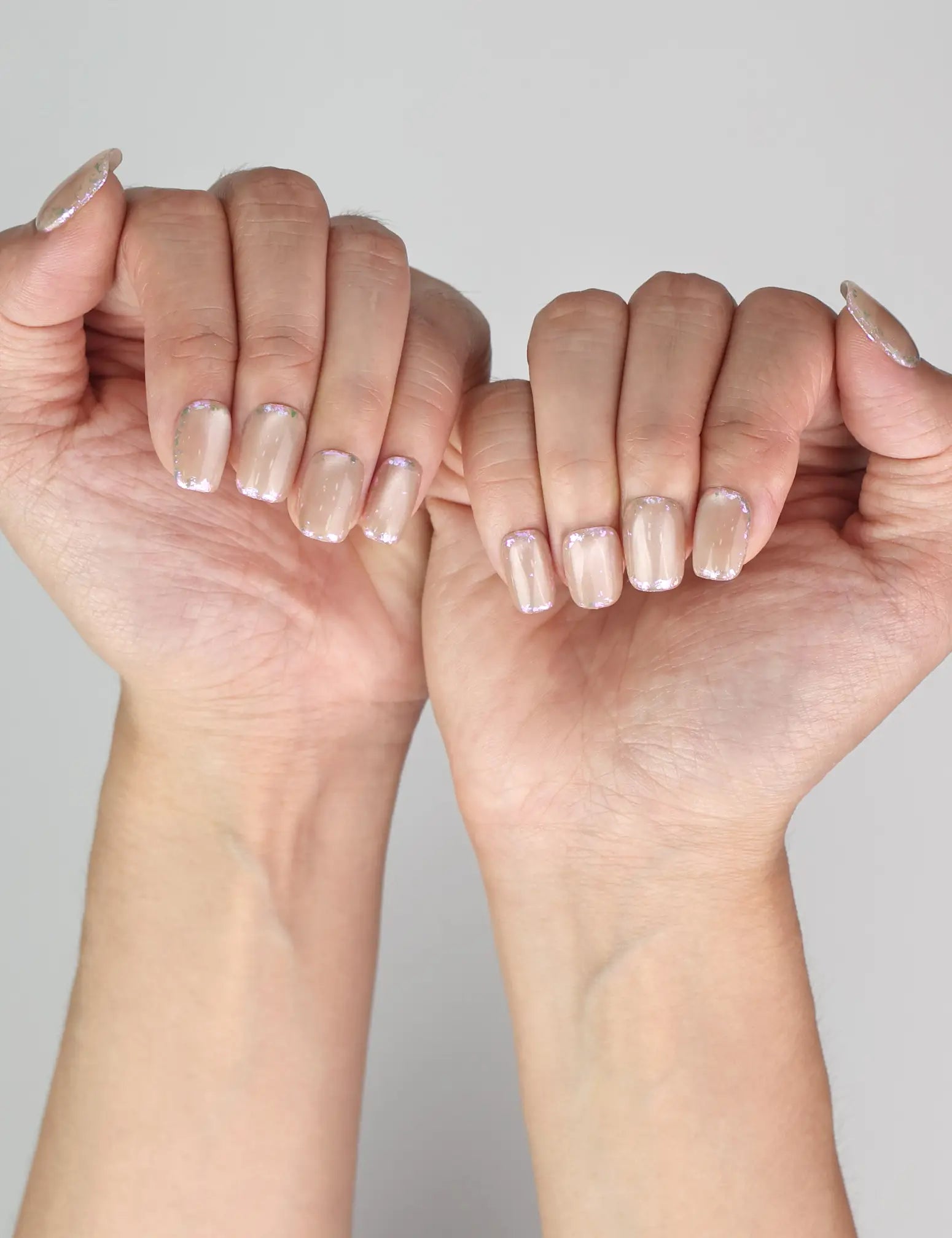 Elegant look of Naillover Lucent Blooms handmade Singapore press on nails in soft pastel hues on model’s hand.