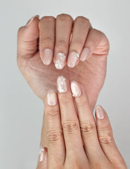 Close-up of Naillover Lucid Petals Singapore press on nails featuring delicate gold floral motifs and pearls.