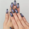 Hand wearing Naillover Lunar Eclipse press on nails, black to purple ombre design in natural lighting