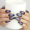 Hand holding cup with Naillover Lunar Eclipse press on nails, stylish black to purple ombre gradient set