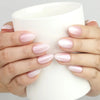 Hand with Naillover Mauve Shine Singapore press on nails in mauve pink shimmer holding a ceramic cup for lifestyle display