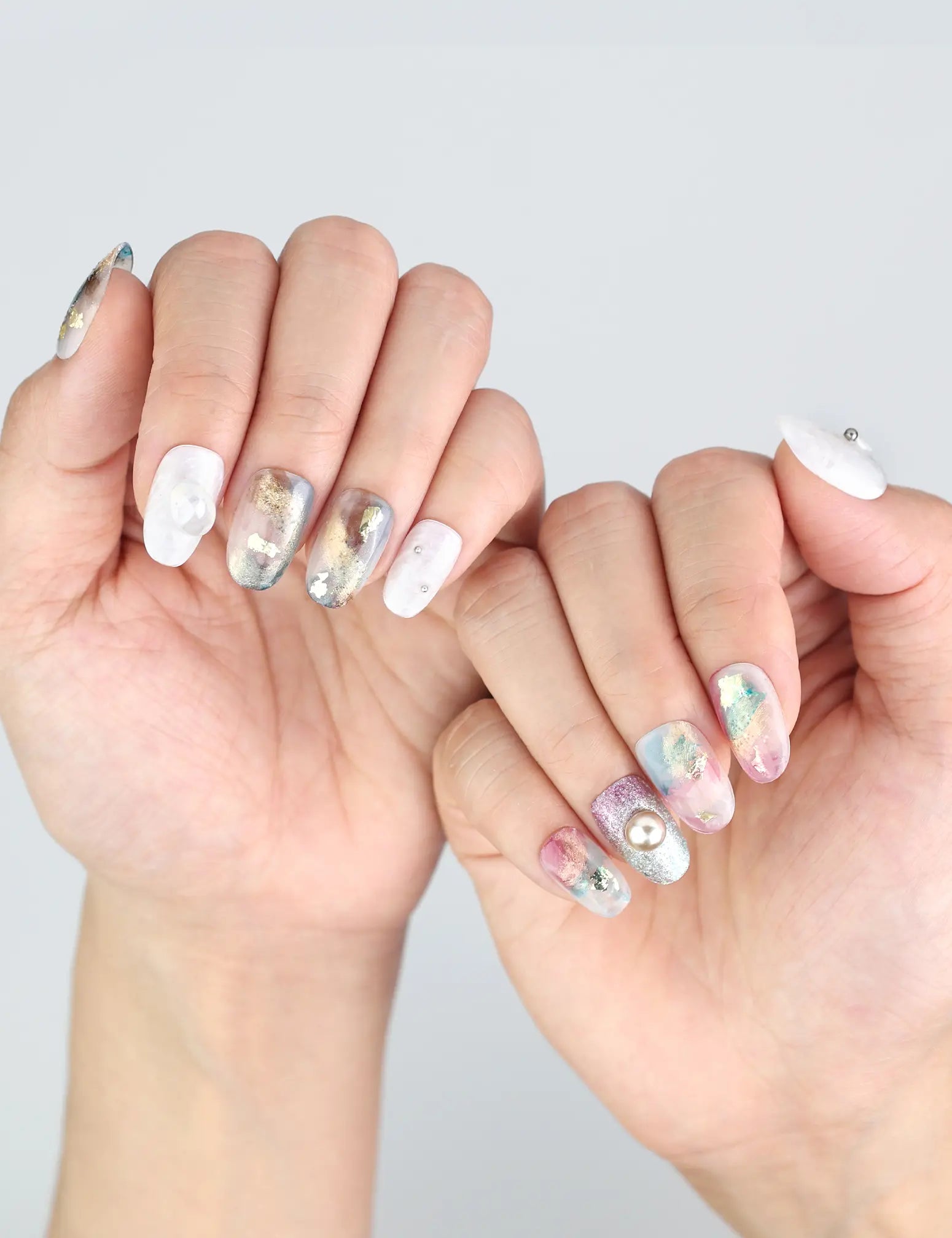 Fingers adorned with Naillover Mermaid Sparkle press ons, showing off bold Y2K-style nail art.