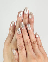 Model wearing Naillover Metallic Glam Singapore press on nails, silver and black geometric glossy finish