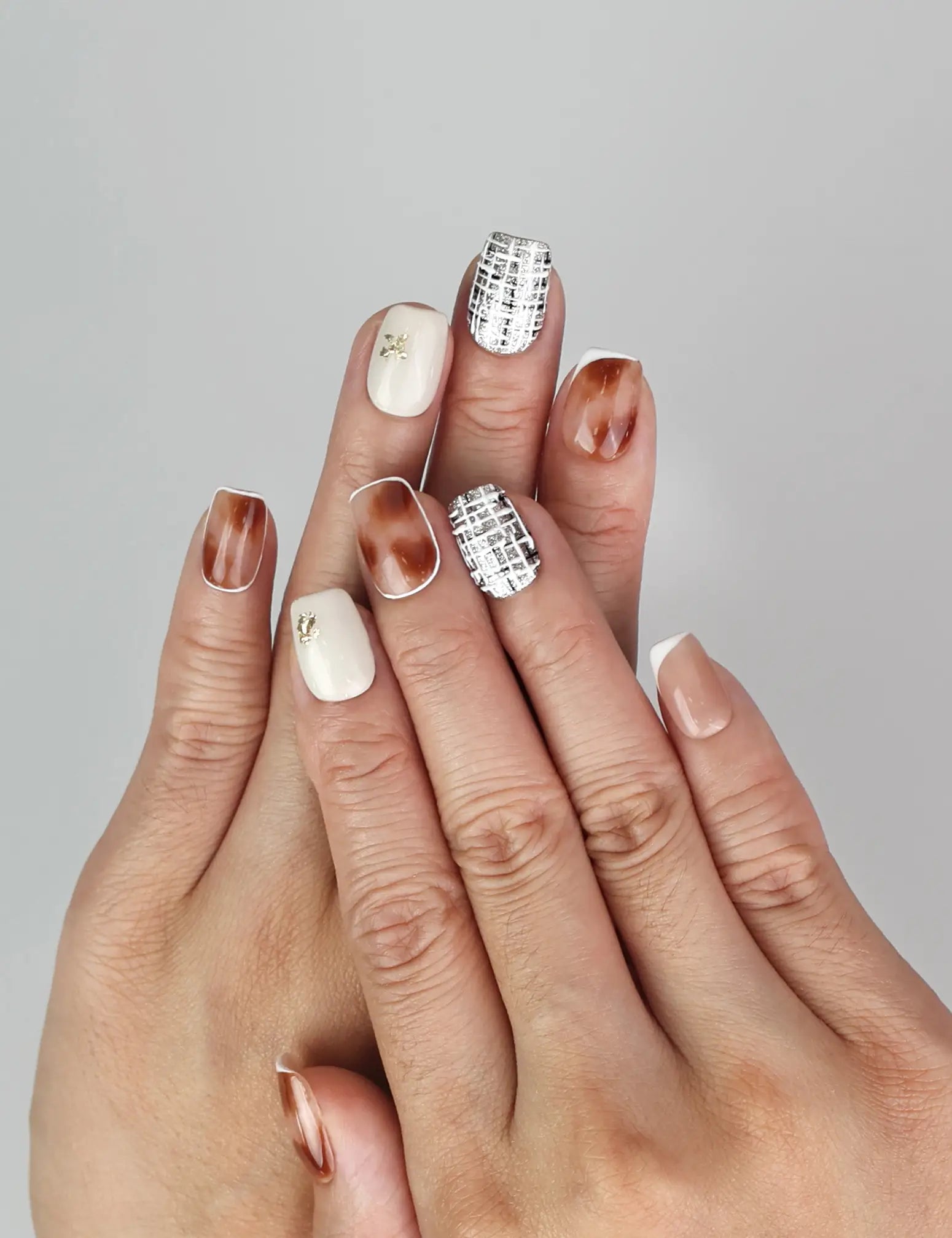 Model wearing Naillover Mocha Matrix handmade Singapore press on nails in neutral shades with glossy finish.