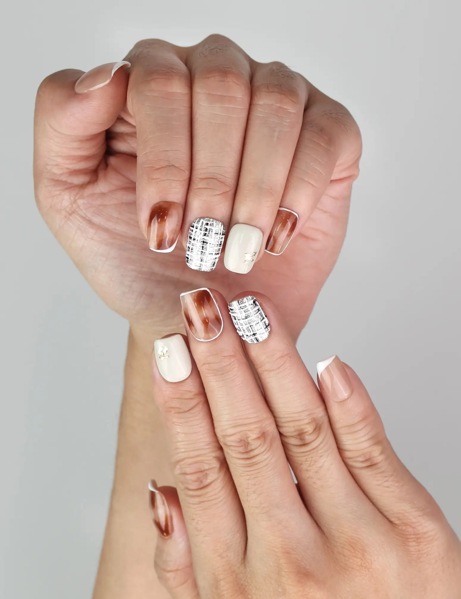 Close-up of Naillover Mocha Matrix trendy handmade press on nails with gold accents and chic patterns.